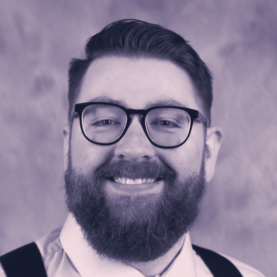 Jacob Little, smiling, in glasses and suspenders
