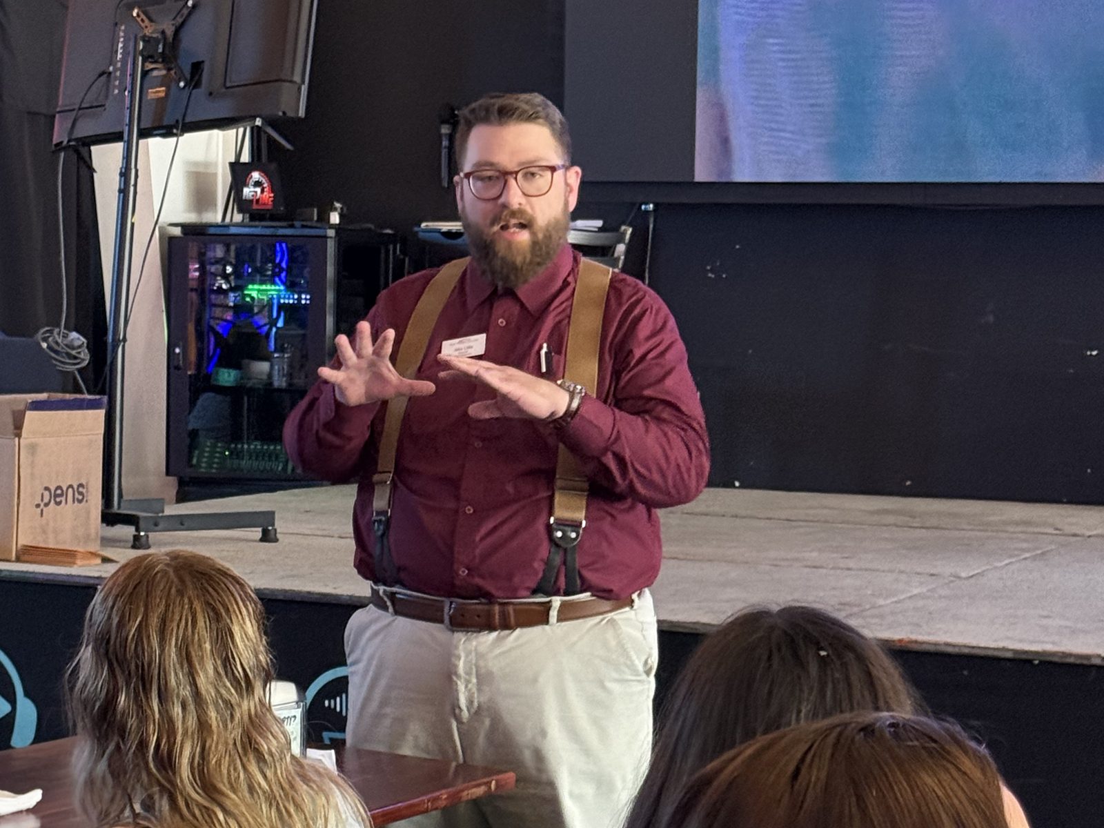 Jacob Little speaking to a seated audience, gesturing with both hands